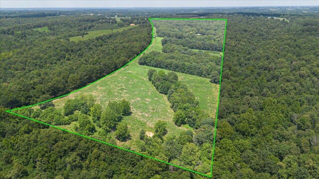 drone / aerial view featuring a wooded view