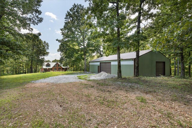 view of yard featuring a garage and an outdoor structure