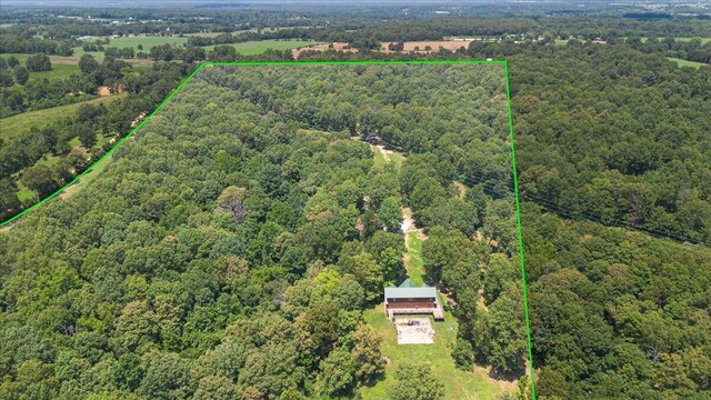 birds eye view of property with a wooded view