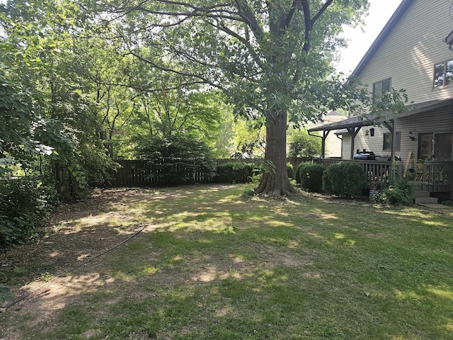 view of yard with fence and a deck