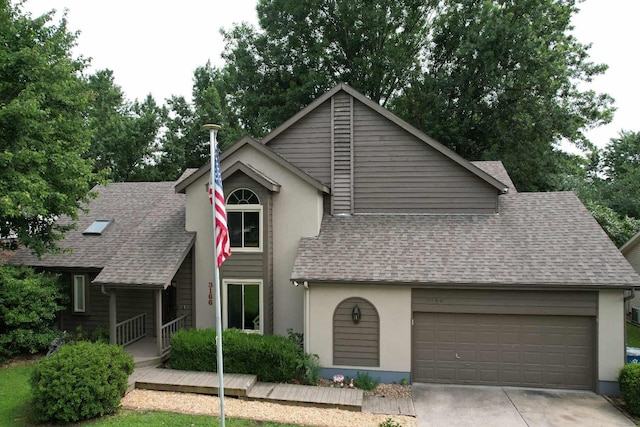 view of front of property featuring stucco siding, concrete driveway, an attached garage, and a shingled roof