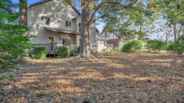 3166 W Seminole St, Springfield, MO 65807 - back of property with a wooden deck and a chimney