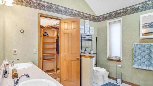 3166 W Seminole St, Springfield, MO 65807 - full bath featuring lofted ceiling, toilet, a walk in closet, double vanity, and tile patterned floors