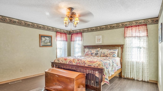 3166 W Seminole St, Springfield, MO 65807 - bedroom featuring wood finished floors, a textured ceiling, baseboards, and a ceiling fan