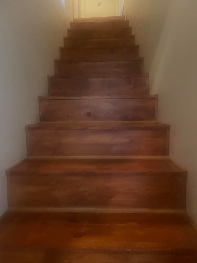 stairs featuring hardwood / wood-style floors