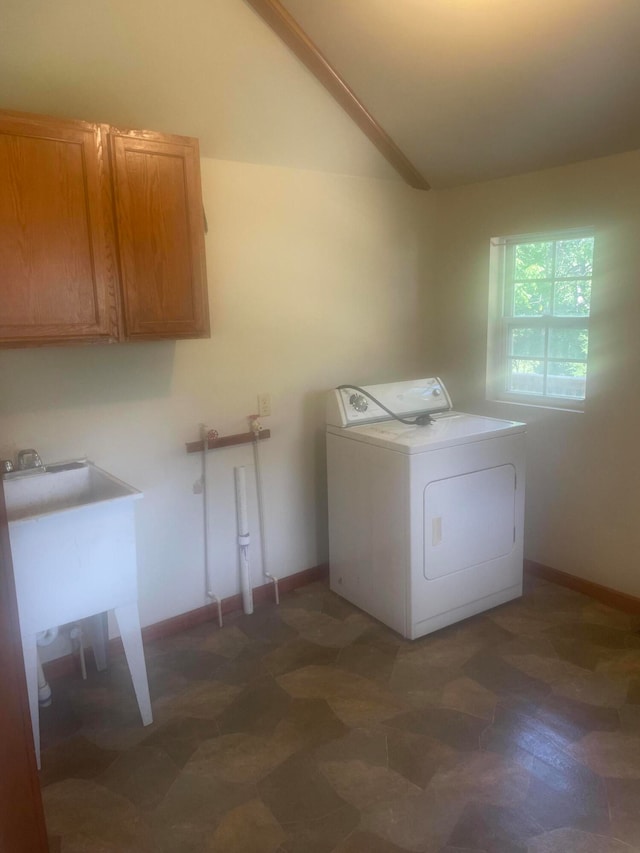 washroom featuring washer / clothes dryer and cabinets