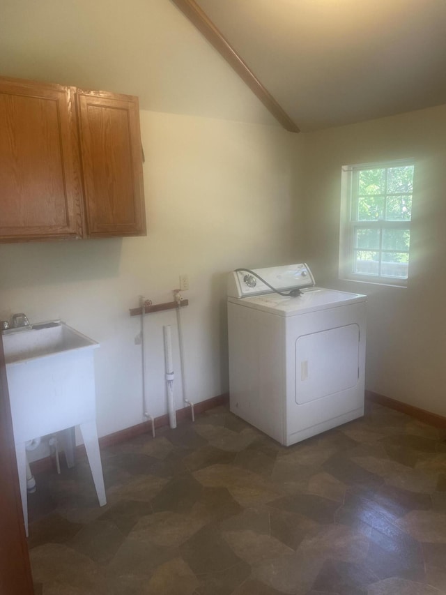 clothes washing area featuring a sink, cabinet space, and washer / dryer