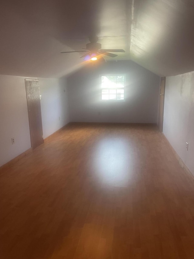 bonus room featuring vaulted ceiling, ceiling fan, and light wood-style flooring