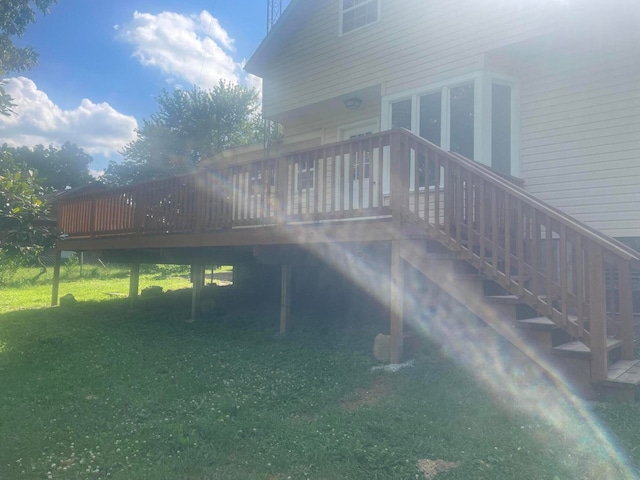 back of property with a yard and a wooden deck