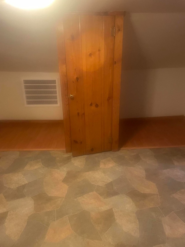 bonus room with hardwood / wood-style floors