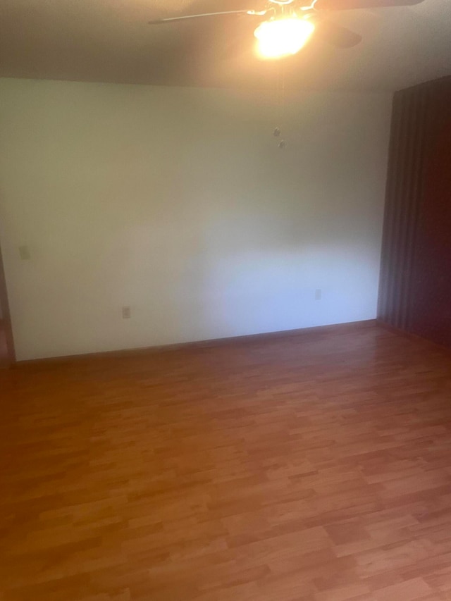 spare room featuring light hardwood / wood-style floors and ceiling fan