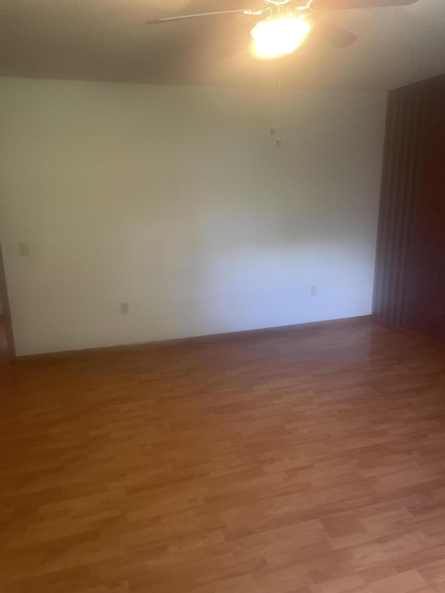 spare room featuring a ceiling fan and light wood finished floors