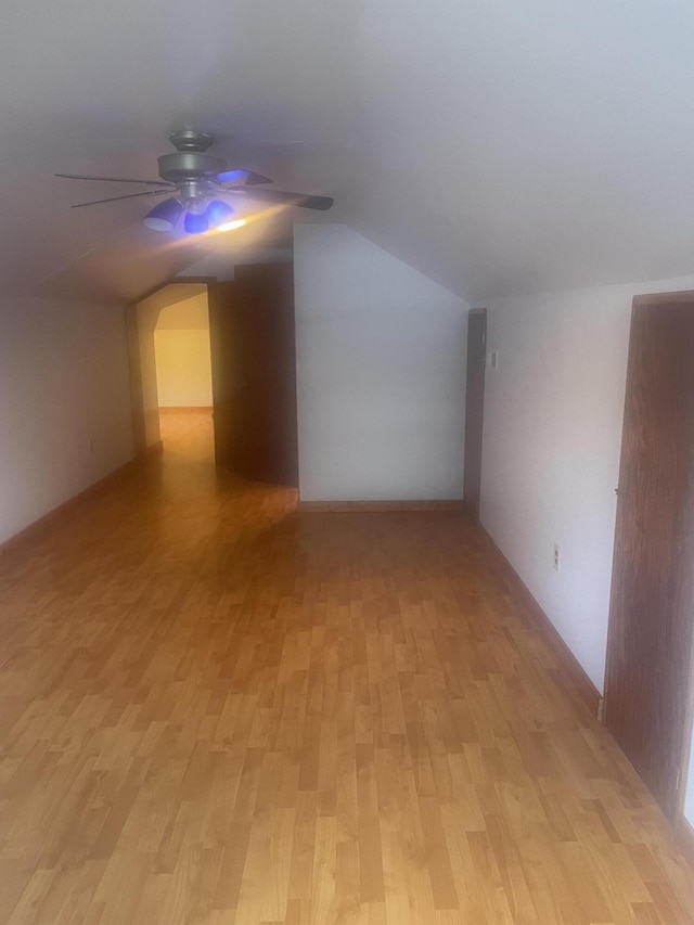 additional living space featuring ceiling fan, vaulted ceiling, and light wood finished floors