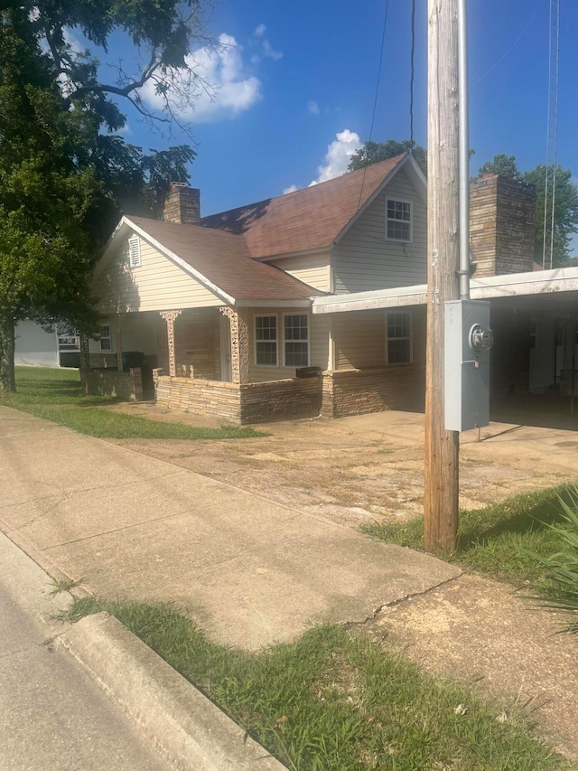 view of side of property with a carport