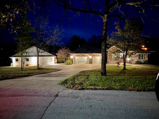 ranch-style house with a yard and a garage