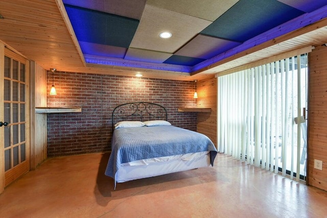 bedroom with wood walls and concrete floors