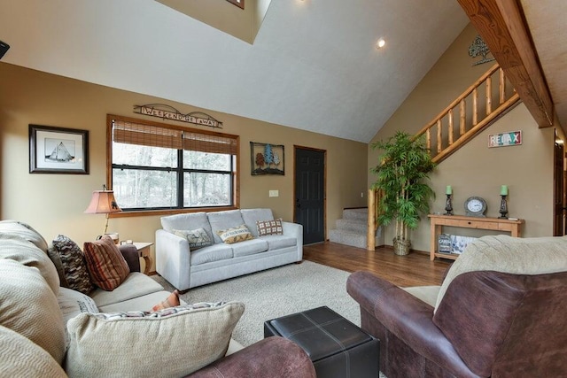 living room featuring wood-type flooring, beamed ceiling, and high vaulted ceiling