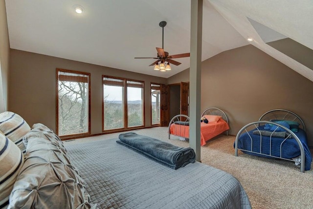 carpeted bedroom with ceiling fan and vaulted ceiling