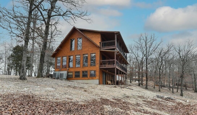 back of house with a balcony and central AC