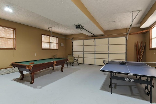 playroom featuring concrete flooring, a textured ceiling, and pool table