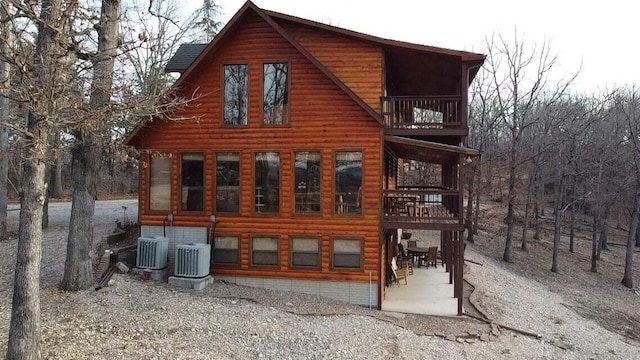 view of home's exterior featuring cooling unit and a balcony