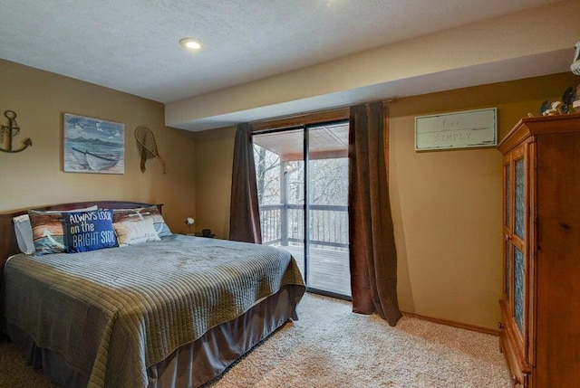 carpeted bedroom featuring access to exterior and a textured ceiling