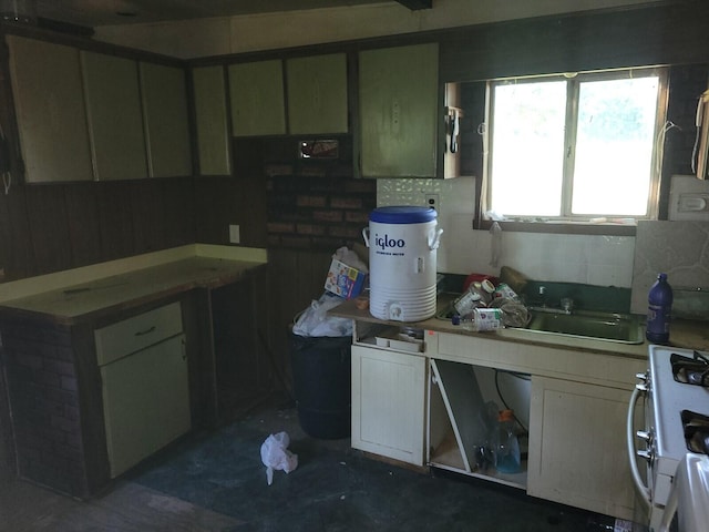 kitchen featuring sink and white range with gas cooktop