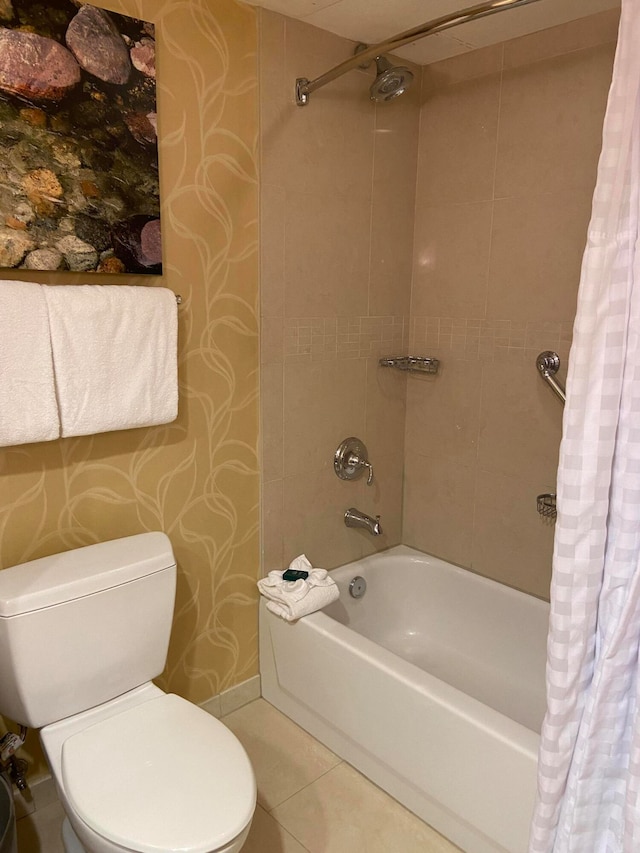 bathroom featuring tile patterned floors, shower / tub combo, and toilet