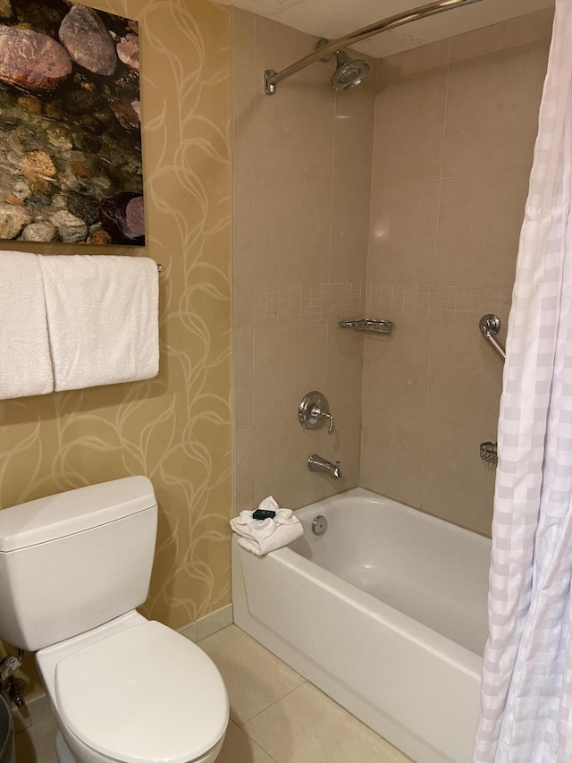 bathroom featuring shower / bath combo with shower curtain, tile patterned flooring, and toilet