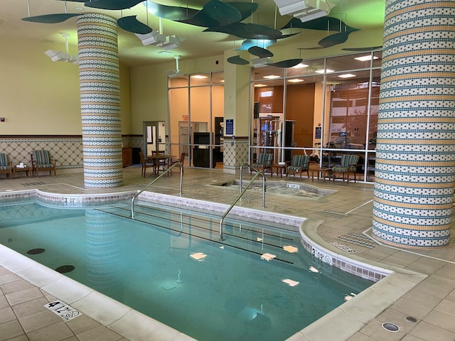 view of swimming pool with an indoor hot tub