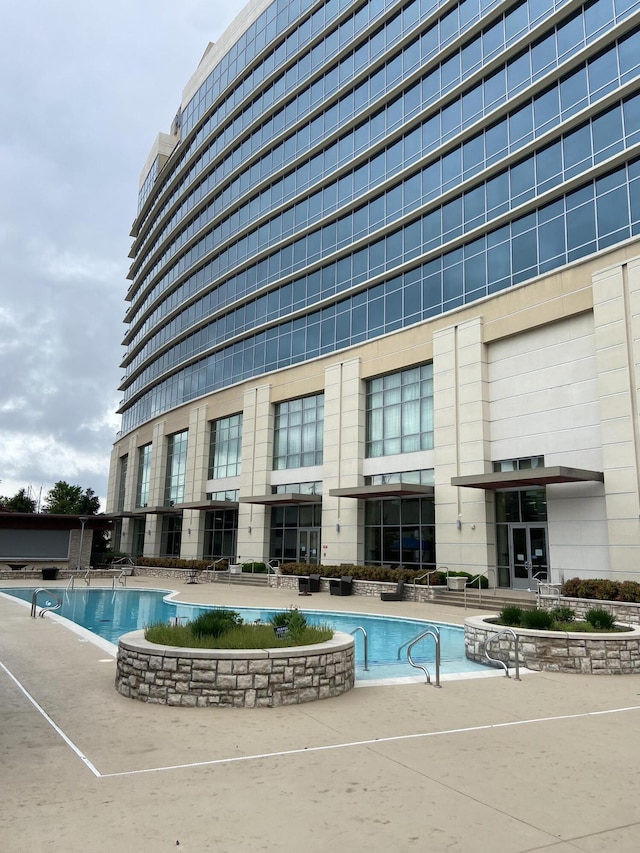 community pool with a patio area