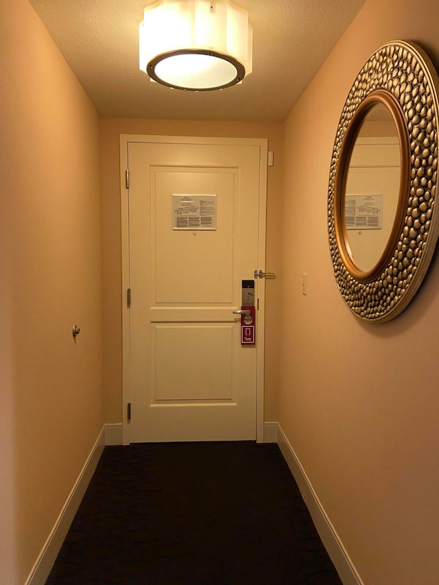 doorway featuring a textured ceiling