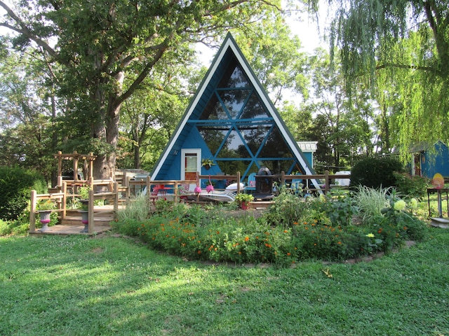 back of property with a lawn and a deck