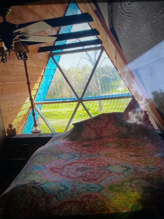 bedroom featuring wood walls