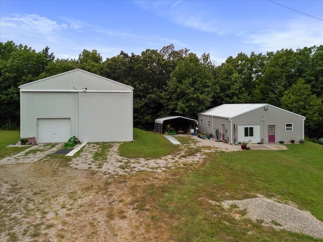 view of yard featuring a garage, an outbuilding, a carport, and a pole building