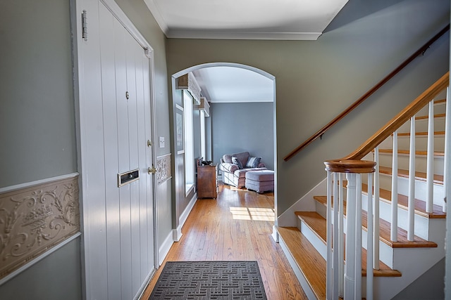1011 E University St, Springfield, MO 65807 - entrance foyer featuring arched walkways, hardwood / wood-style flooring, stairway, and ornamental molding