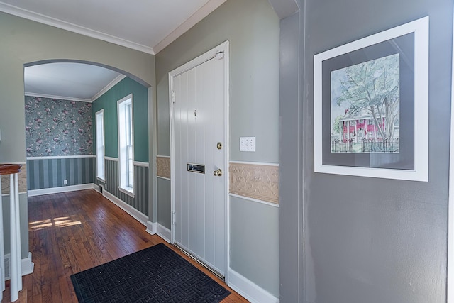 1011 E University St, Springfield, MO 65807 - entrance foyer featuring ornamental molding, wallpapered walls, hardwood / wood-style floors, a wainscoted wall, and arched walkways