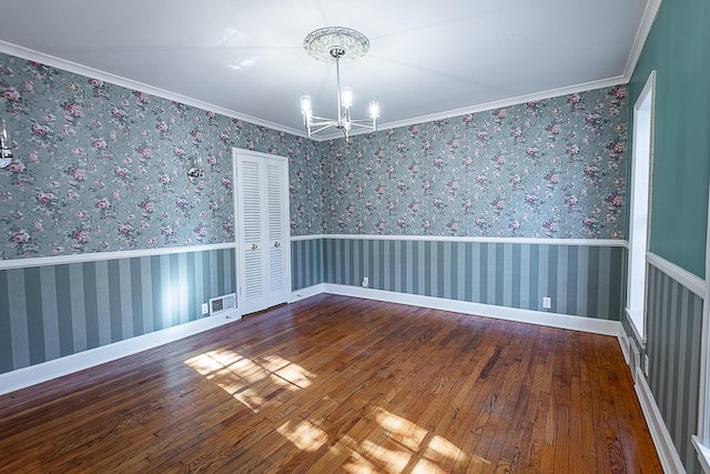 1011 E University St, Springfield, MO 65807 - spare room featuring a chandelier, hardwood / wood-style floors, and crown molding