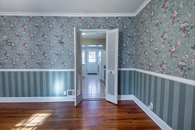 1011 E University St, Springfield, MO 65807 - empty room featuring wood finished floors and crown molding