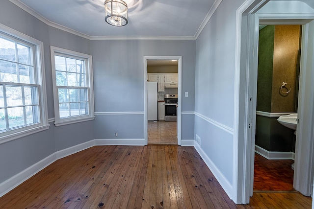 1011 E University St, Springfield, MO 65807 - unfurnished dining area featuring dark wood finished floors and ornamental molding