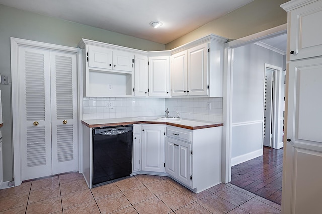 1011 E University St, Springfield, MO 65807 - kitchen with black dishwasher, white cabinets, and light countertops