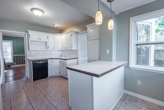 1011 E University St, Springfield, MO 65807 - kitchen with dishwasher, plenty of natural light, white cabinets, and a peninsula