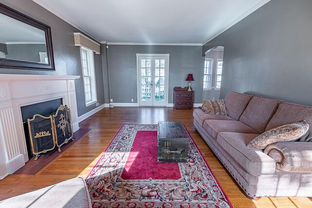 1011 E University St, Springfield, MO 65807 - living area featuring arched walkways, crown molding, wood finished floors, and a fireplace with flush hearth