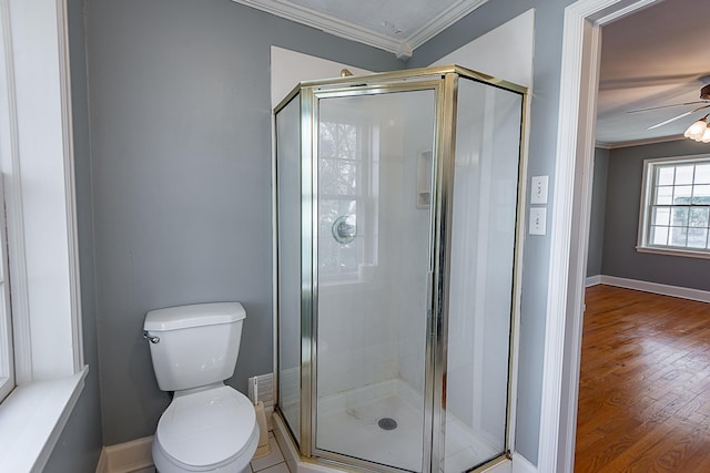 1011 E University St, Springfield, MO 65807 - bathroom featuring crown molding, a shower stall, a ceiling fan, and wood finished floors