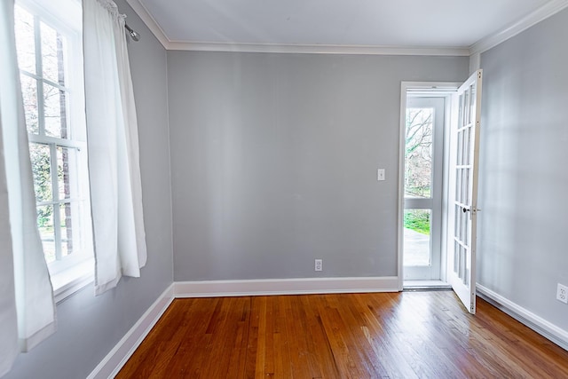 1011 E University St, Springfield, MO 65807 - empty room featuring crown molding, wood-type flooring, and plenty of natural light
