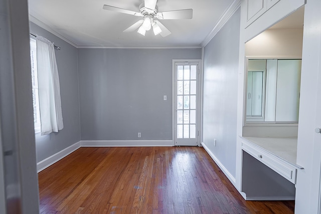 1011 E University St, Springfield, MO 65807 - spare room featuring hardwood / wood-style flooring, ornamental molding, and a ceiling fan