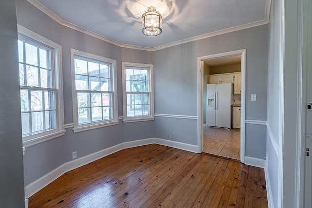 1011 E University St, Springfield, MO 65807 - empty room featuring hardwood / wood-style floors, ornamental molding, and a chandelier