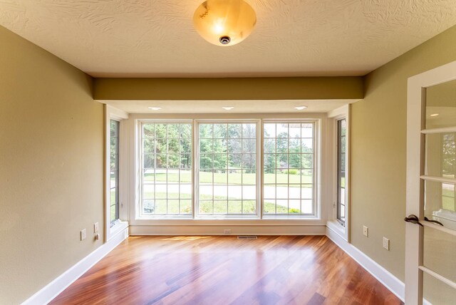 unfurnished sunroom with plenty of natural light