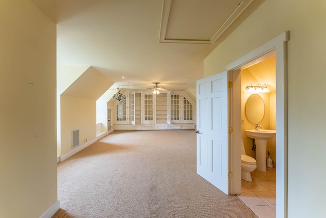 bonus room featuring ceiling fan, lofted ceiling, light carpet, and sink