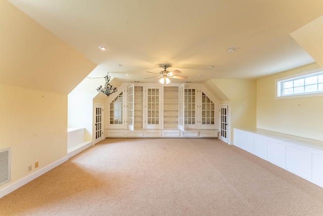 additional living space with light carpet, ceiling fan, and lofted ceiling